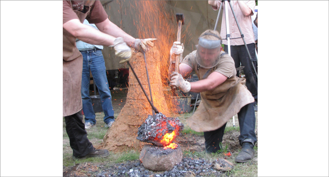 Iron smelting experiments conducted in a bloomery of the type discovered in Glienicke. A lump of iron created within this experiments are presented at the new exhibition at “Neues Museum”